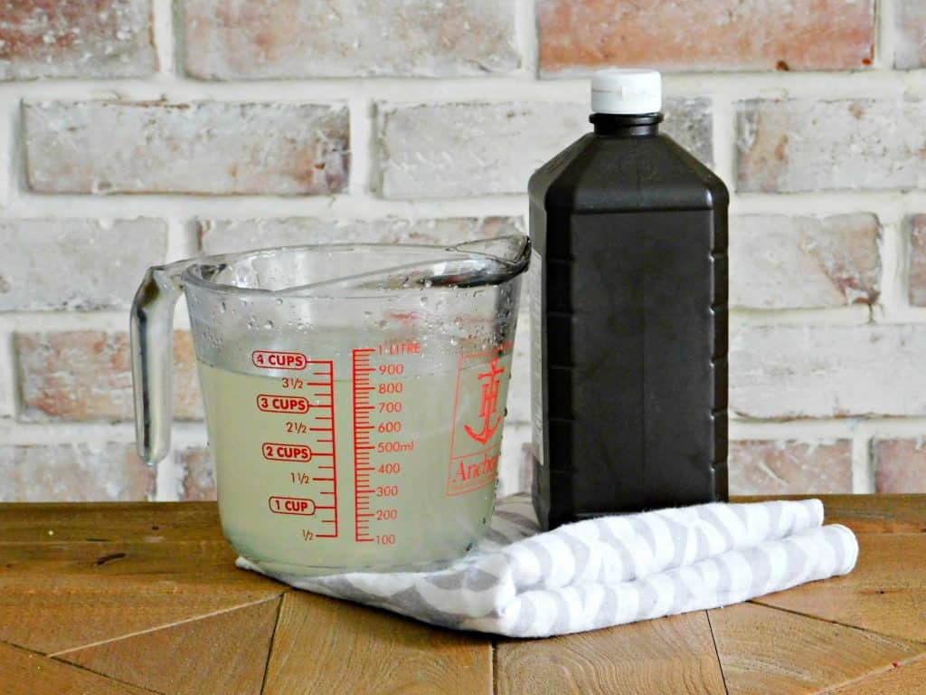 homemade bleach in measuring cup dark bottle of hydrogen peroxide