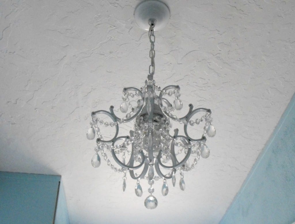 chandelier hanging from the bathroom ceiling