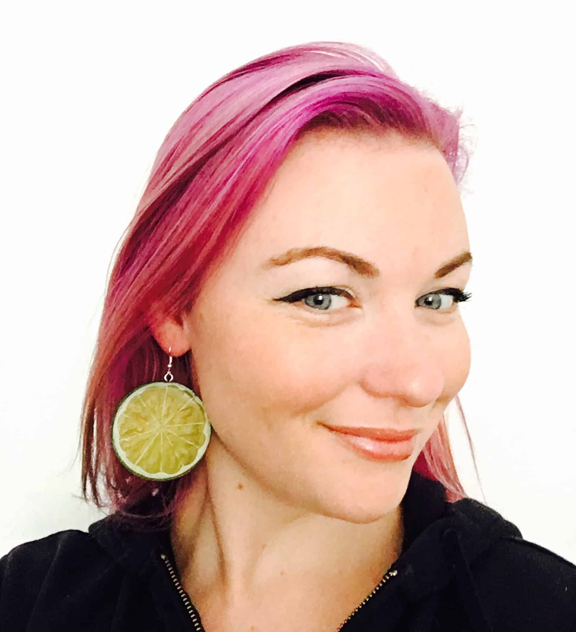 pink hair smiling wearing lemon earrings