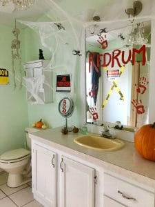 redrum and bloody prints on bathroom mirror