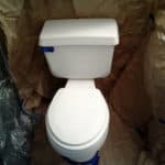 white toilet getting prepped to be painted