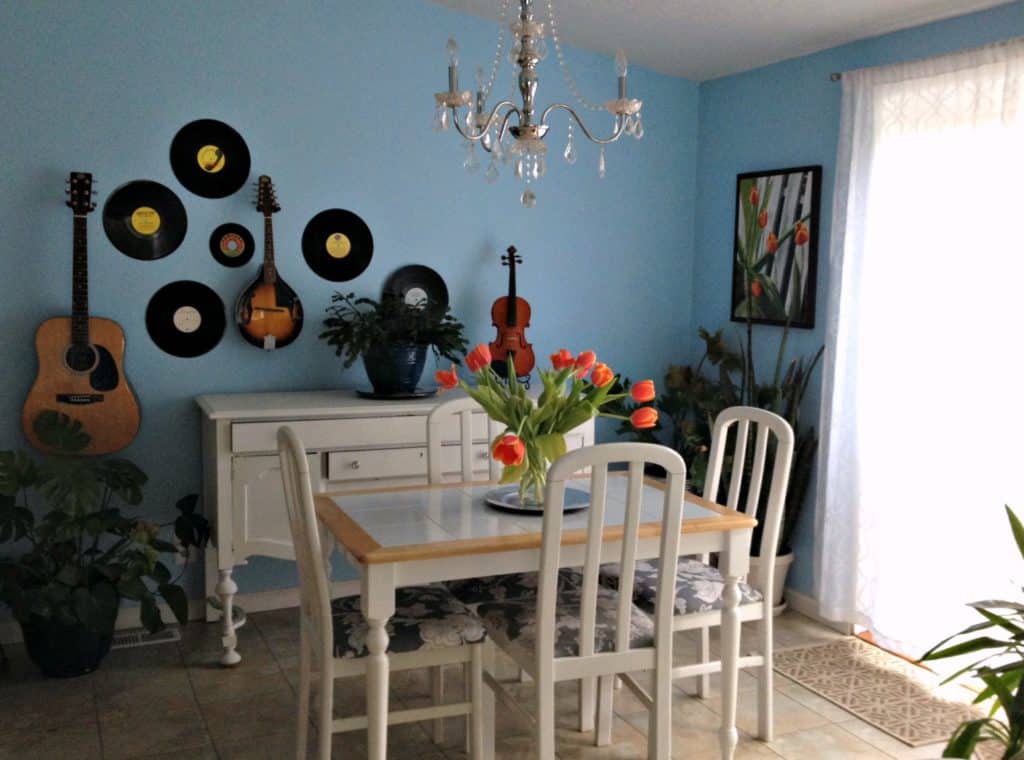 blue dining room with records and instruments on the wall