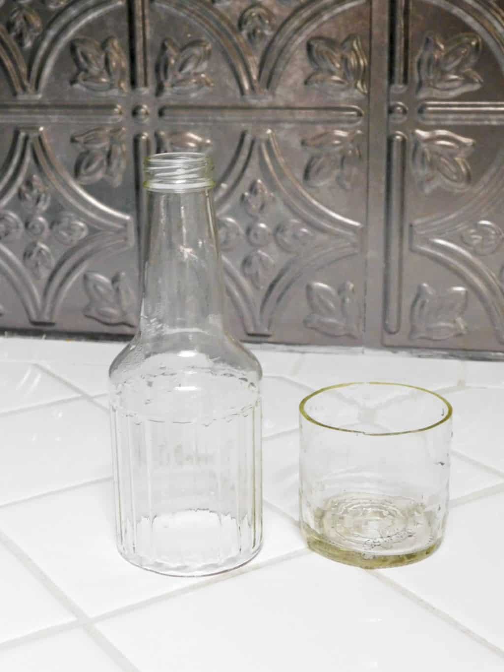 glass bottle cut in half sitting on a white counter