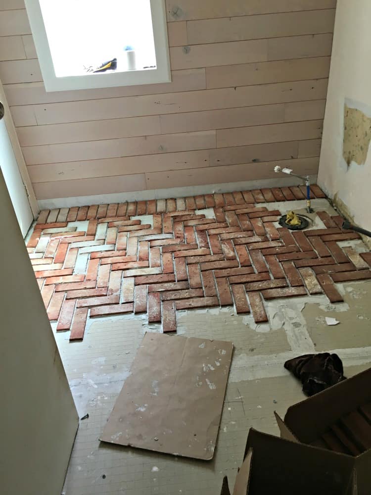 bathroom floor with brick laid out