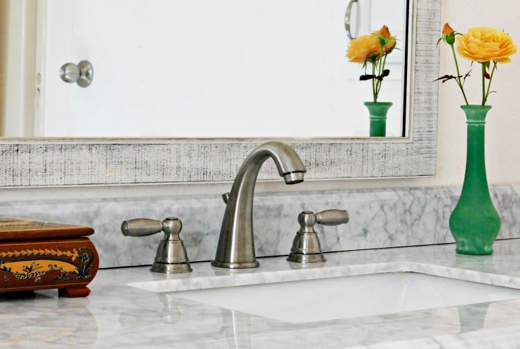 silver faucet on marble counter 