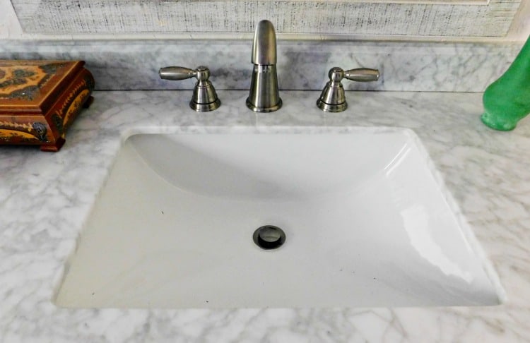 sink with marble counter and silver faucet