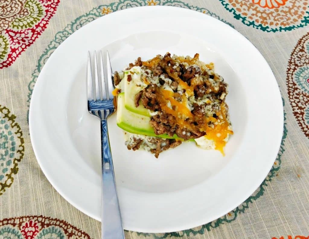 portion of zucchini lasagna on a plate with a fork on the left