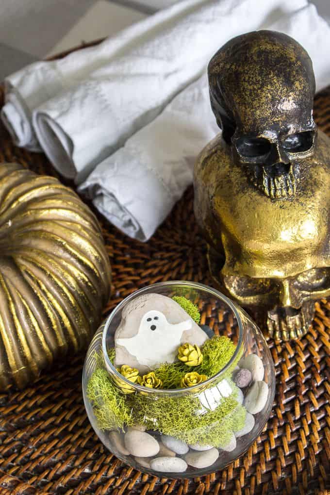Halloween terrarium on display with gold skull decor