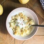 slow cooker garlic mashed potatoes in white bowl