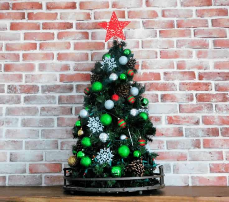 tomato cage christmas tree on counter by brick wall