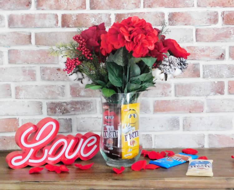 finished chocolate vase full of flowers and packaged m&ms