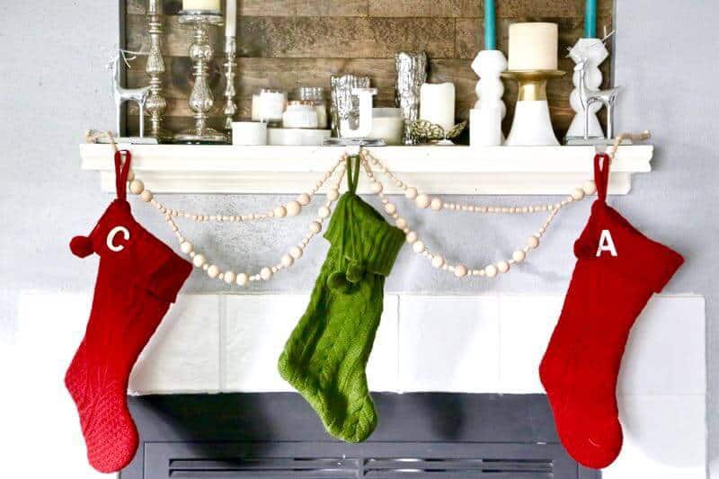 beaded garland with stockings hung on a mantle