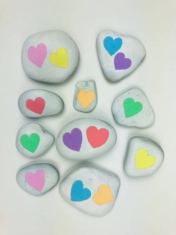 white rocks with colorful hearts on them
