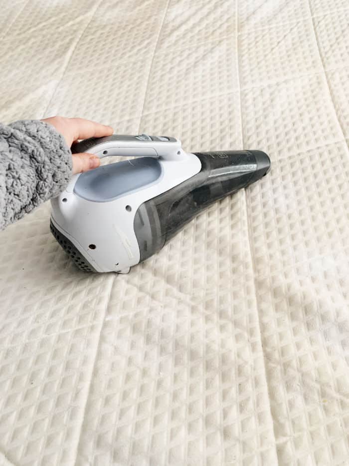 Vacuum the baking soda off the mattress. 