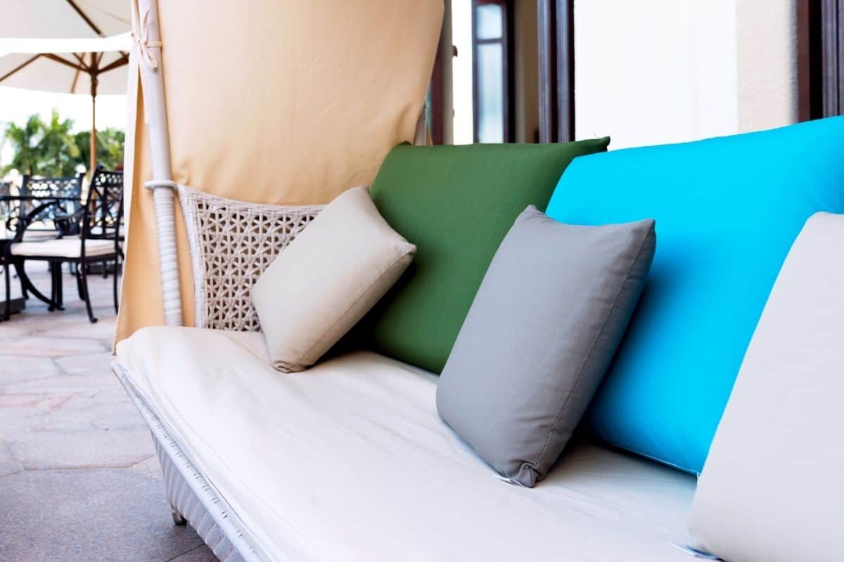 Colorful patio cushions on an outdoor couch.
