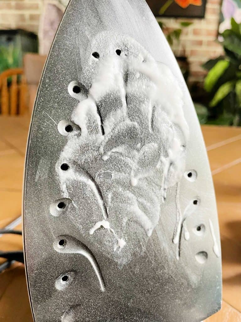 Iron with baking soda paste on front plate.