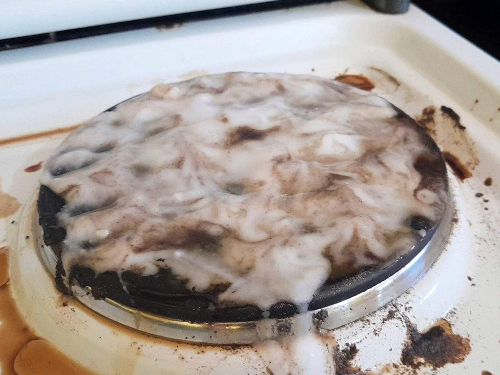 Process of cleaning electric stove using baking soda paste.