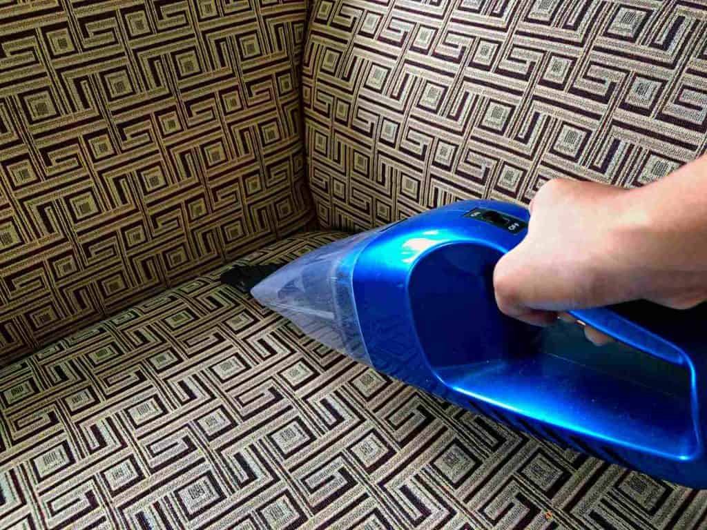 Vacuum step to clean a velvet couch.