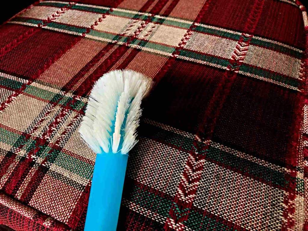 Use of soft-bristled brush to clean patio cushions. 