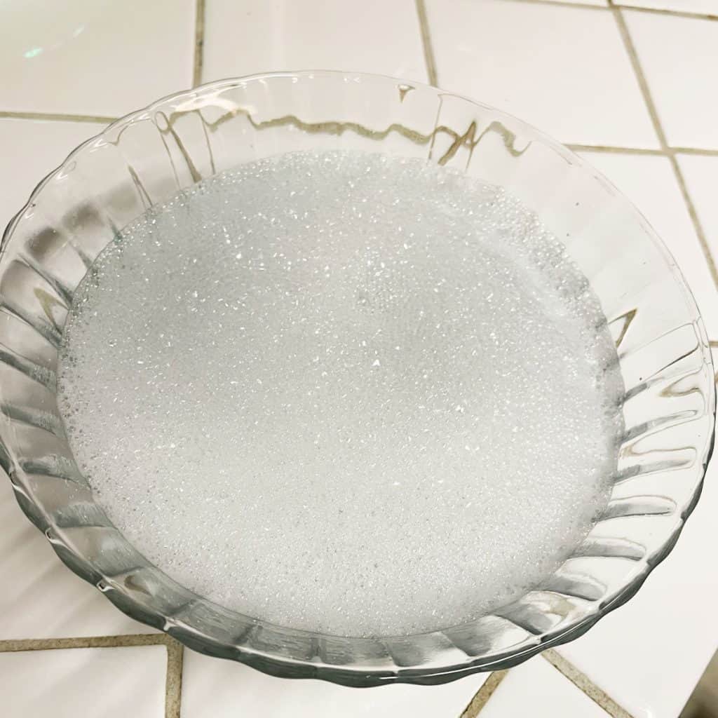 Bowl full of soapy water. 