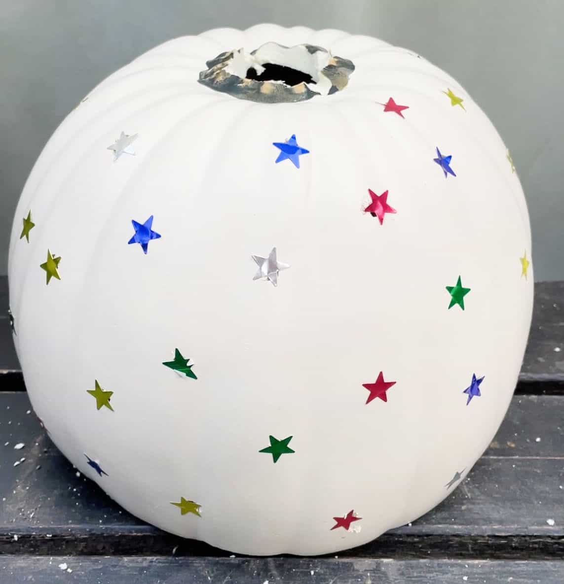 Craft pumpkin with star stickers stuck on.