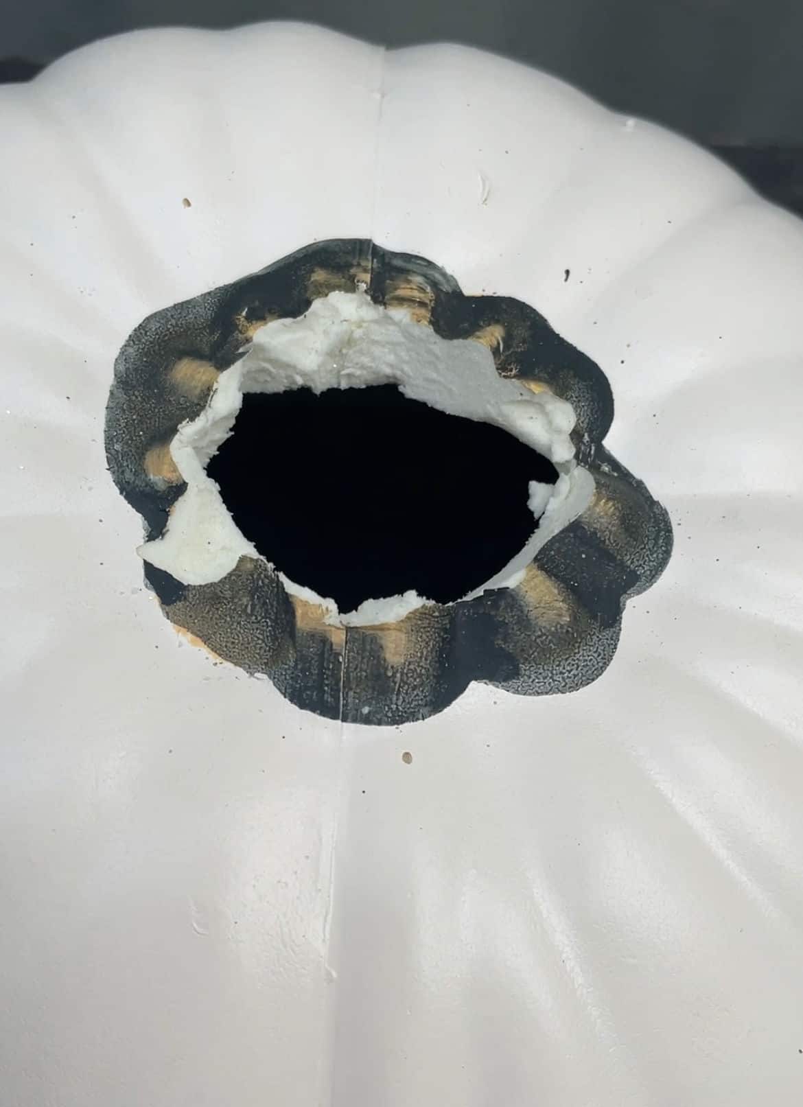 Close up of craft pumpkin with a hole where the stem is.