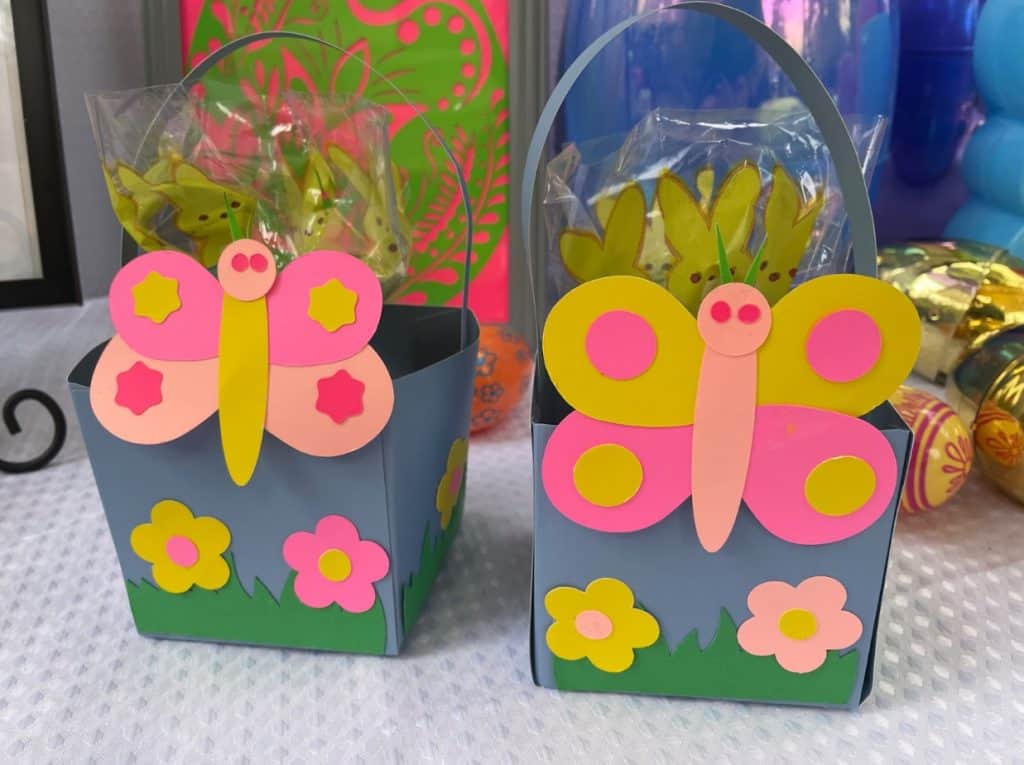 Two butterfly Easter baskets on a table for an Easter Egg Hunt.