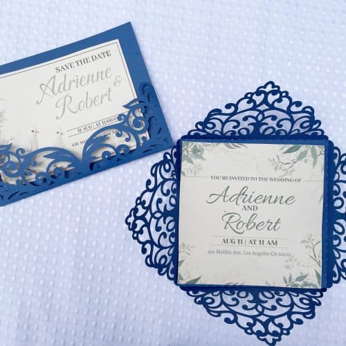 Wedding invitations on a white table cloth.