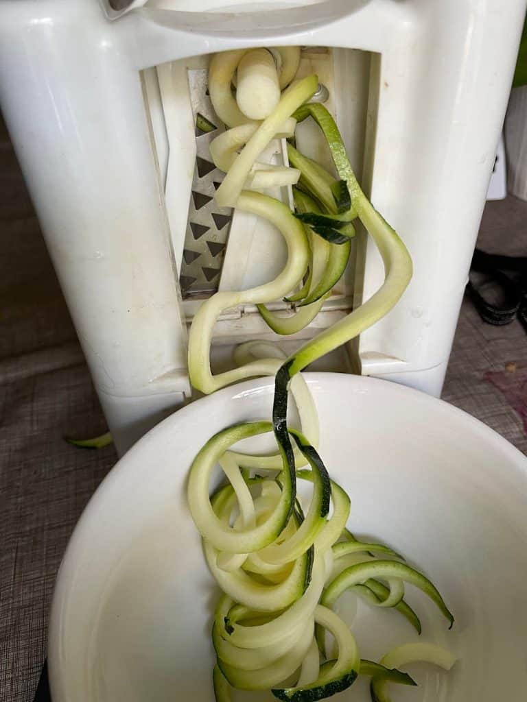 Spiralized zucchini being cut. 