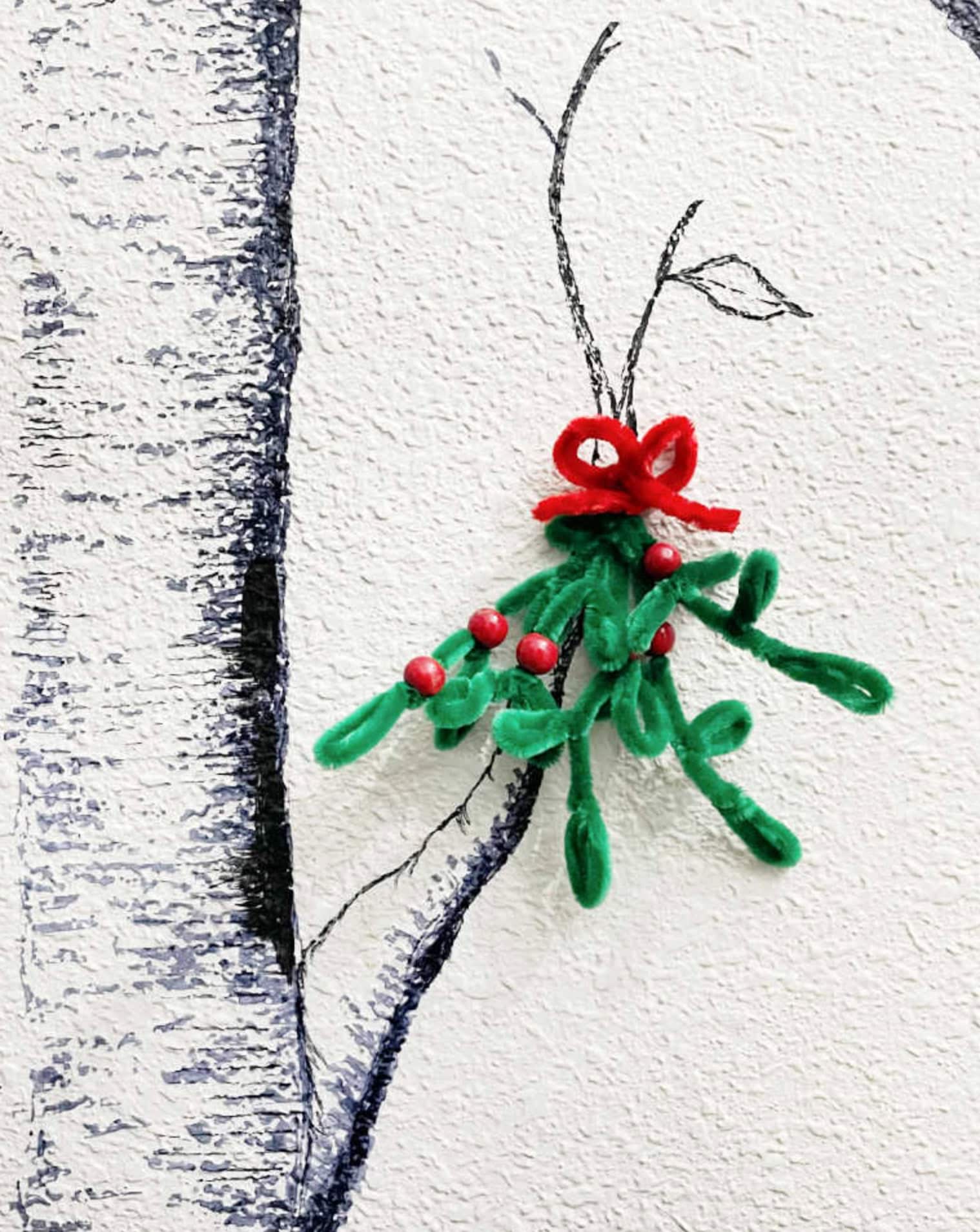 Colorful holiday craft gnome made from pipe cleaners and beads, perfect for Christmas decoration.